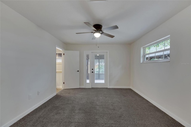 carpeted spare room with ceiling fan