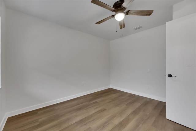 spare room with light wood-type flooring and ceiling fan