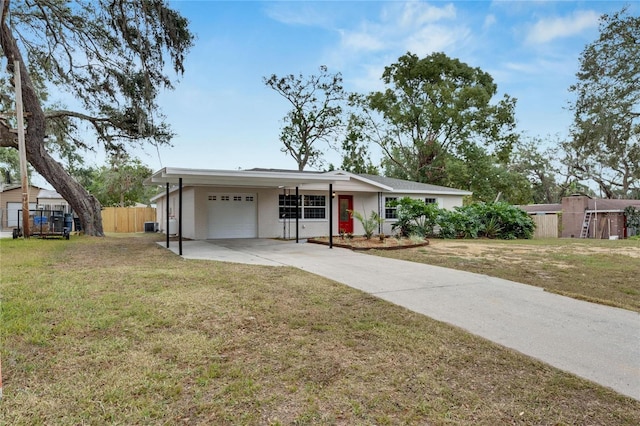 single story home with a garage, fence, a front lawn, and concrete driveway