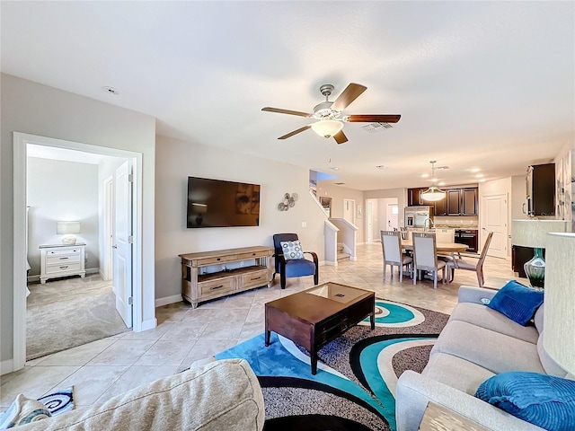 living room featuring ceiling fan and light tile patterned flooring