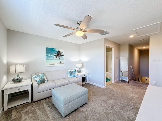 living room featuring ceiling fan, carpet, and a textured ceiling