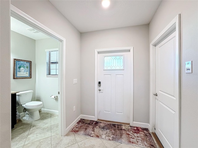 foyer entrance featuring light tile patterned floors