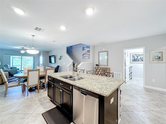 kitchen with dishwasher, sink, hanging light fixtures, ceiling fan, and an island with sink