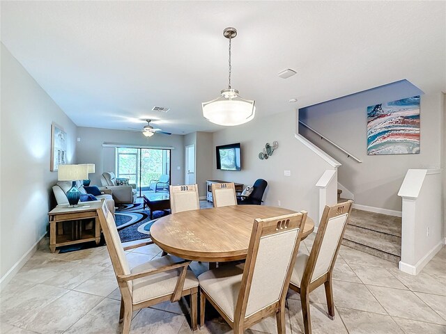 tiled dining space with ceiling fan