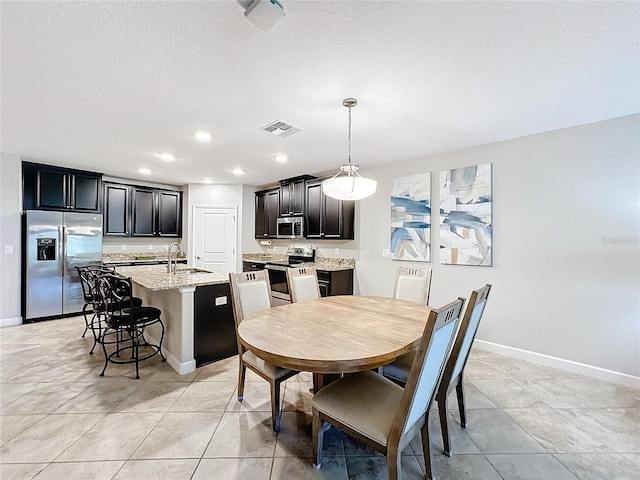 dining room with light tile patterned flooring and sink