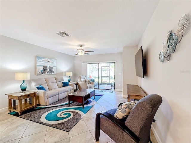 living room with ceiling fan and light tile patterned floors