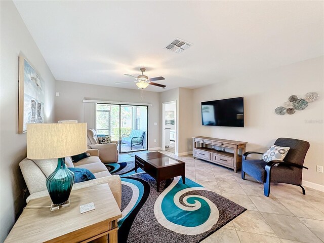 tiled living room with ceiling fan