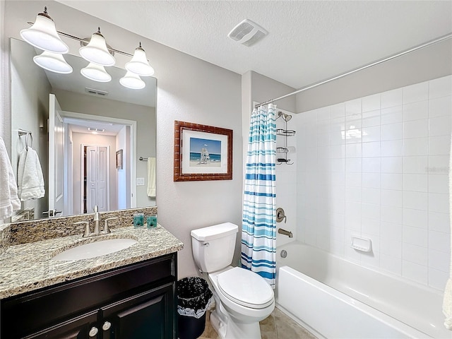 full bathroom with tile patterned floors, vanity, a textured ceiling, shower / bath combo with shower curtain, and toilet