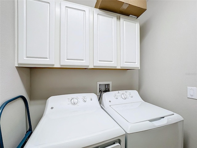 laundry room with cabinets and washer and clothes dryer