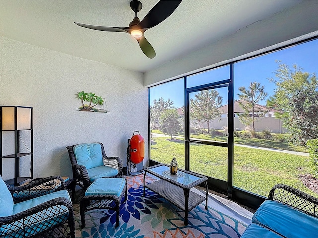 sunroom / solarium featuring ceiling fan