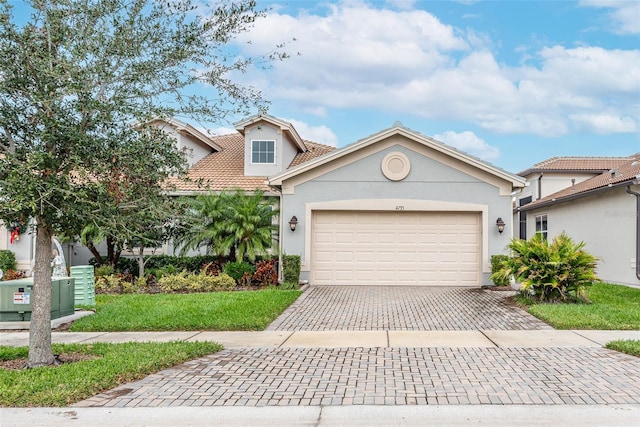 view of front of house featuring a garage and a front lawn