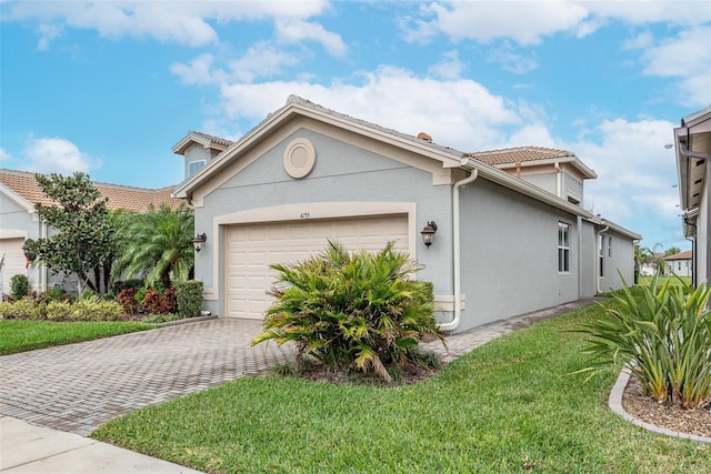 view of front of home with a garage and a front lawn