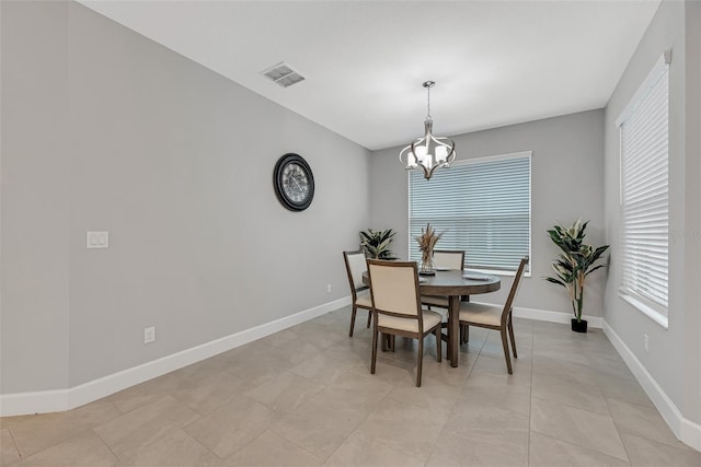 dining area with visible vents, a notable chandelier, baseboards, and light tile patterned floors