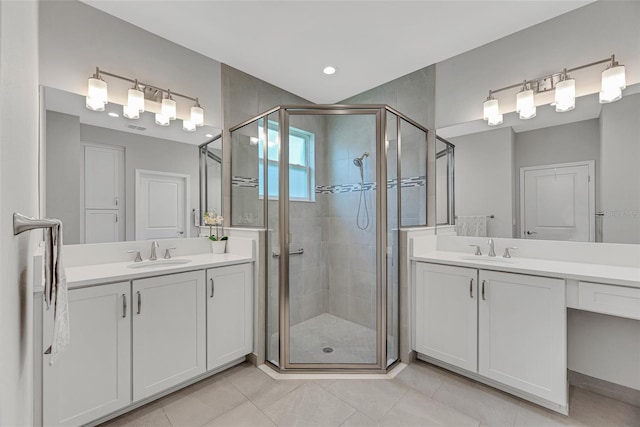 bathroom with two vanities, a sink, and a shower stall