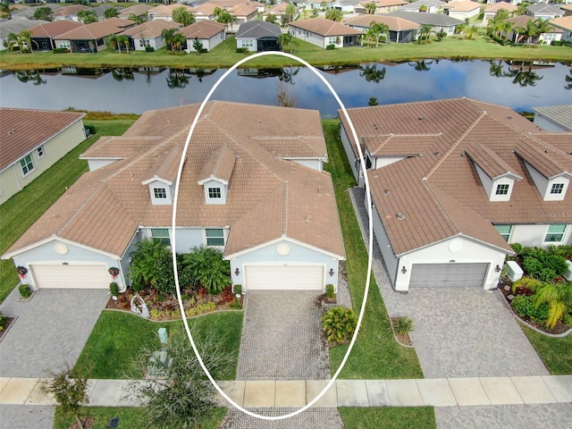 drone / aerial view with a residential view and a water view