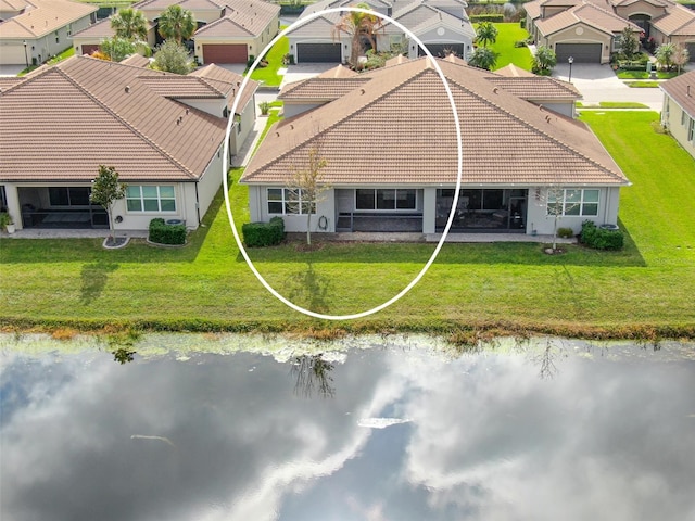 birds eye view of property featuring a water view and a residential view