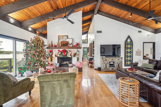 living room featuring wood ceiling, beam ceiling, light wood-type flooring, and high vaulted ceiling