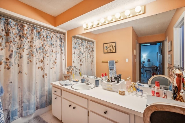 bathroom featuring tile patterned flooring, a textured ceiling, vanity, and a shower with shower curtain