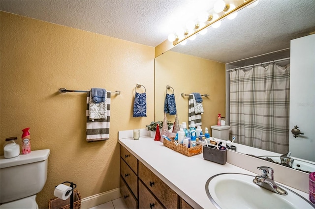 bathroom with tile patterned floors, vanity, a textured ceiling, toilet, and curtained shower