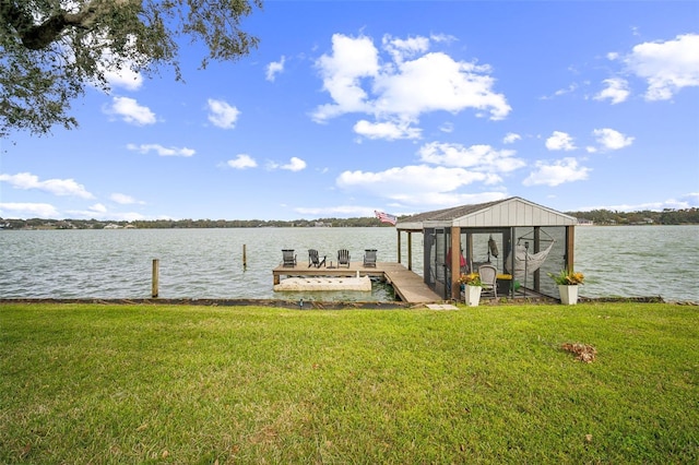 dock area featuring a water view and a lawn