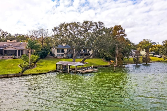 view of dock featuring a water view and a yard