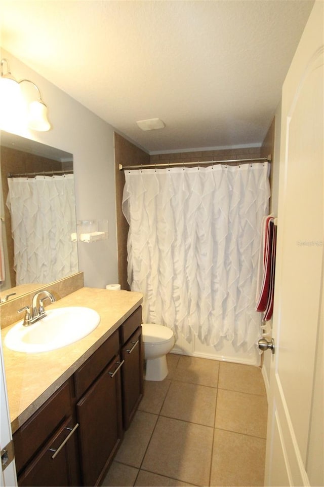 full bathroom featuring tile patterned flooring, vanity, shower / tub combo, and toilet