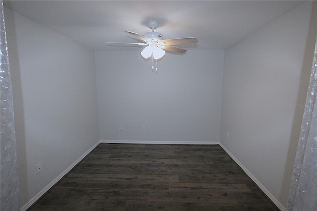 unfurnished room with dark hardwood / wood-style flooring and ceiling fan