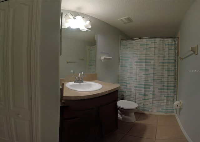 full bathroom featuring vanity, tile patterned floors, toilet, a textured ceiling, and shower / tub combo with curtain