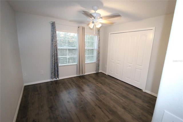 unfurnished bedroom with ceiling fan, dark hardwood / wood-style floors, and a closet