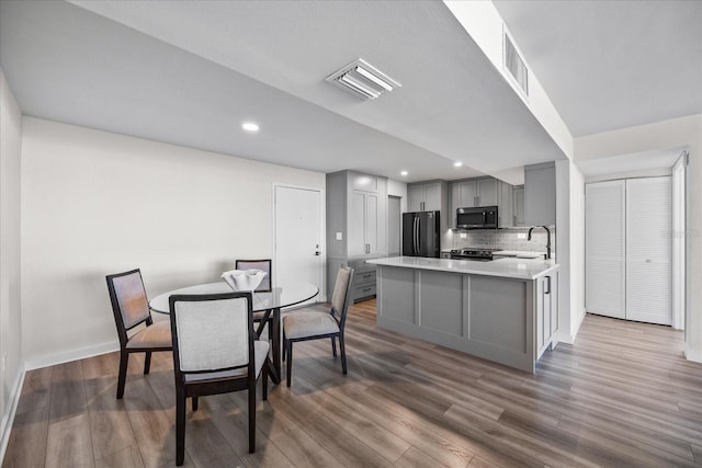 dining space with dark hardwood / wood-style floors and sink