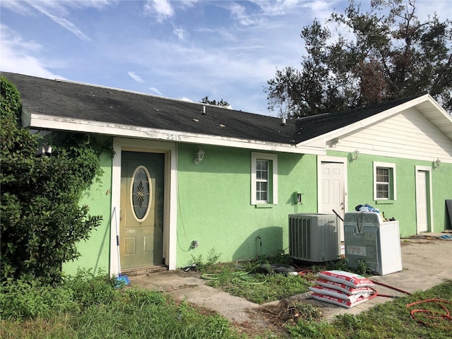 rear view of house with central AC unit