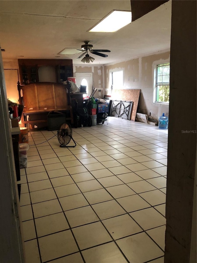 interior space with ceiling fan and light tile patterned flooring