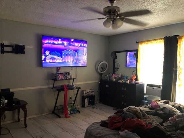 living room featuring ceiling fan, cooling unit, and a textured ceiling