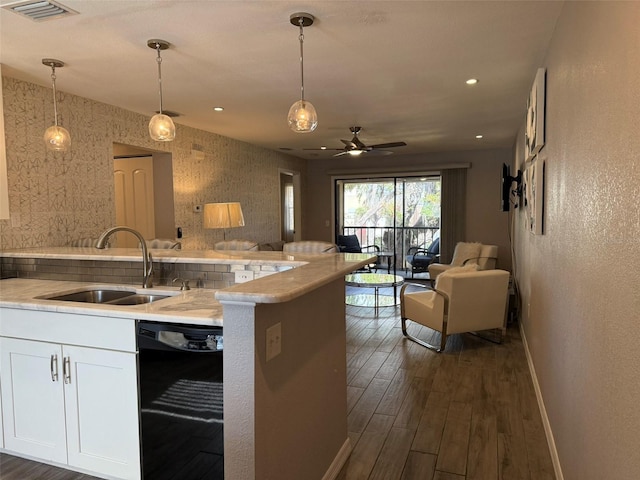 kitchen featuring white cabinets, sink, black dishwasher, decorative light fixtures, and dark hardwood / wood-style flooring