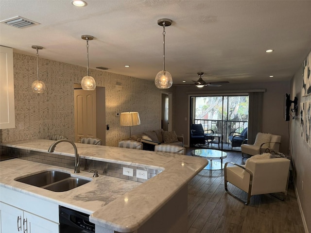 kitchen featuring white cabinets, dark hardwood / wood-style floors, sink, and hanging light fixtures