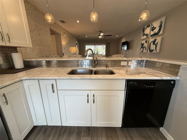 kitchen with white cabinets, black dishwasher, hanging light fixtures, and sink