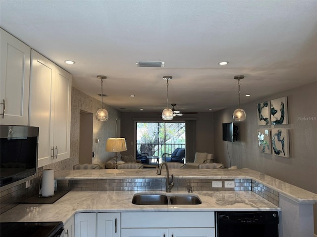 kitchen with kitchen peninsula, sink, decorative light fixtures, white cabinets, and black dishwasher