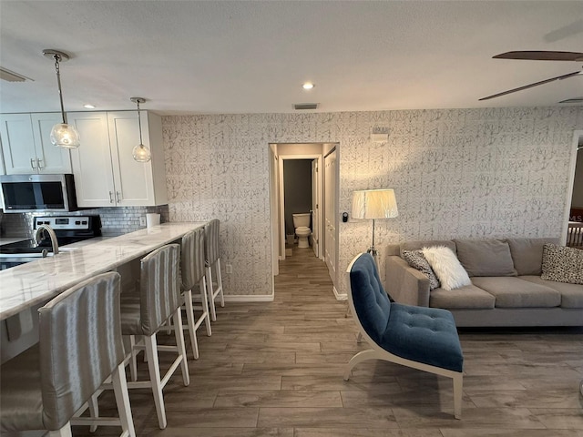 living room featuring dark hardwood / wood-style floors and ceiling fan