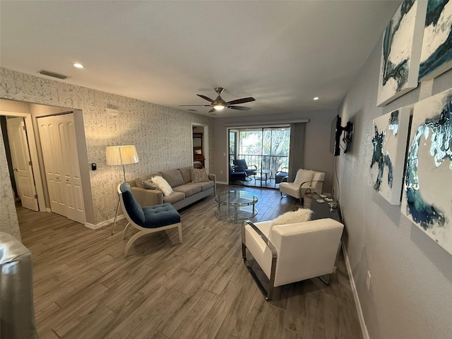 living room with hardwood / wood-style floors and ceiling fan