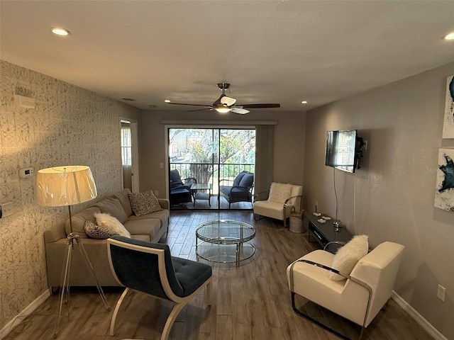 living room featuring ceiling fan and hardwood / wood-style flooring