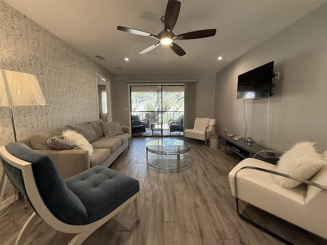 living room featuring hardwood / wood-style floors and ceiling fan