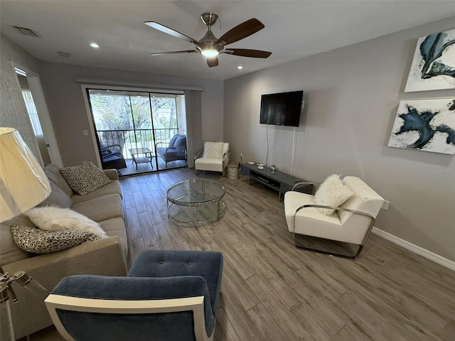 living room featuring ceiling fan and wood-type flooring