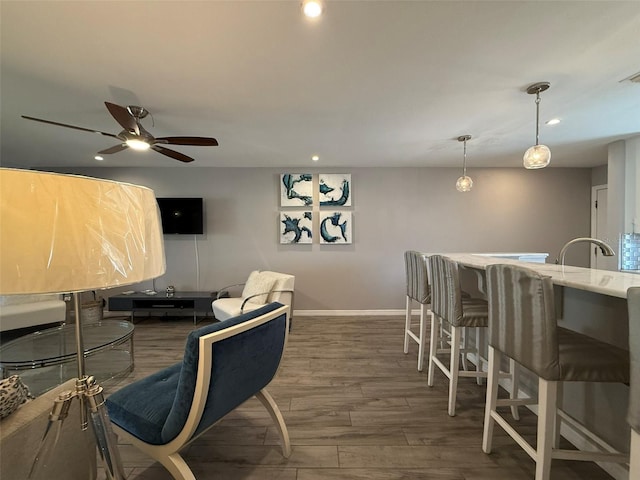 interior space featuring ceiling fan and dark hardwood / wood-style flooring