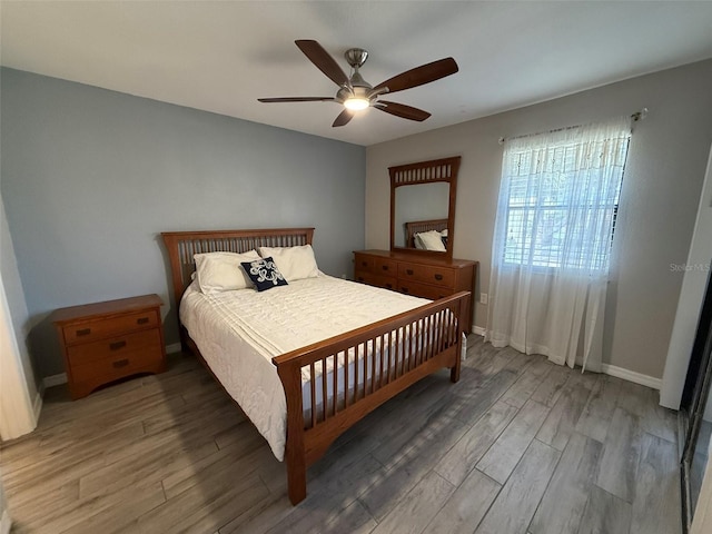 bedroom with ceiling fan and wood-type flooring