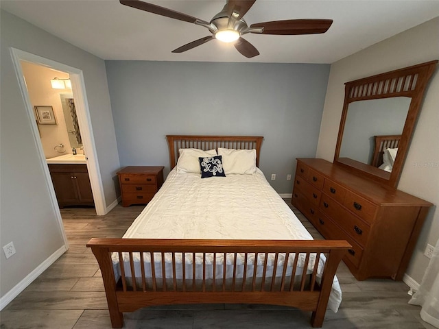 bedroom featuring ensuite bath, ceiling fan, and hardwood / wood-style flooring