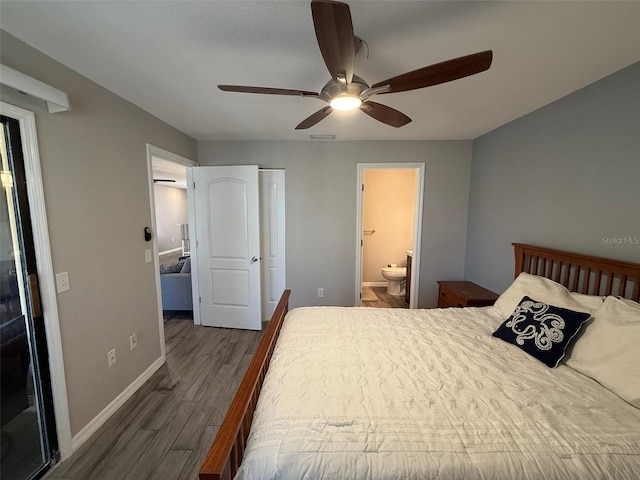 bedroom with dark hardwood / wood-style floors, ceiling fan, and ensuite bath