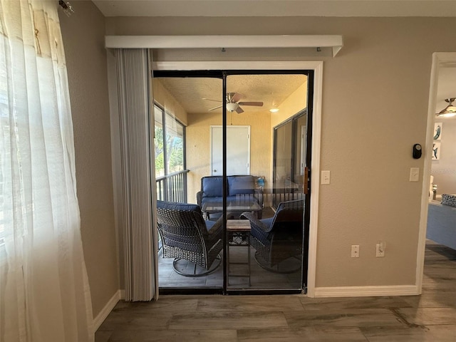 entryway with hardwood / wood-style floors, a textured ceiling, and ceiling fan