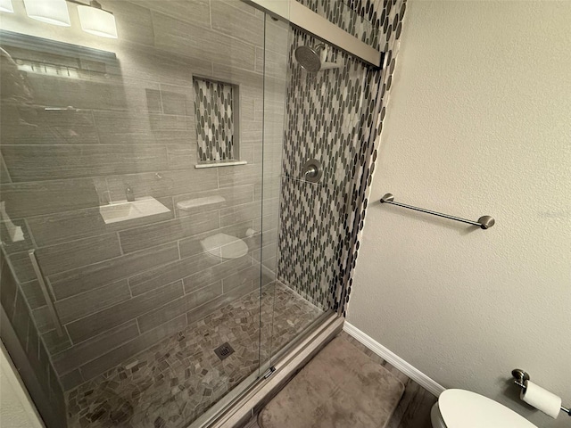 bathroom featuring walk in shower and toilet