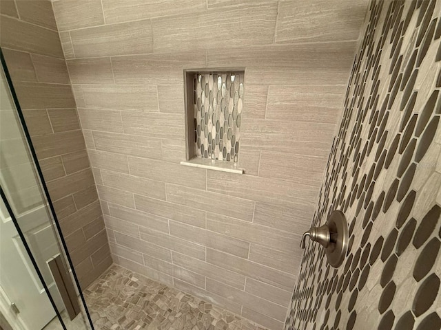 bathroom with a tile shower