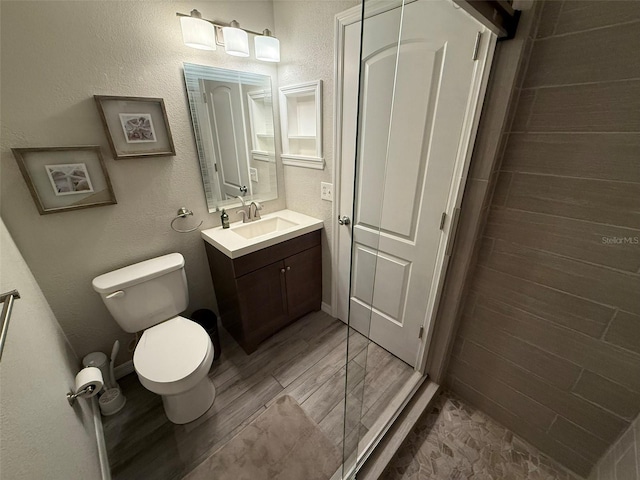 bathroom featuring hardwood / wood-style flooring, vanity, and toilet